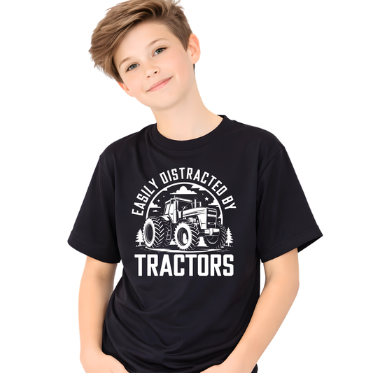 Studio image of boy wearing black Easily Distracted by Tractors youth t-shirt