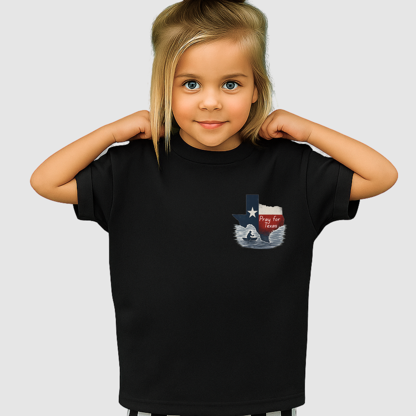Child wearing a black t-shirt with a graphic design on a plain background