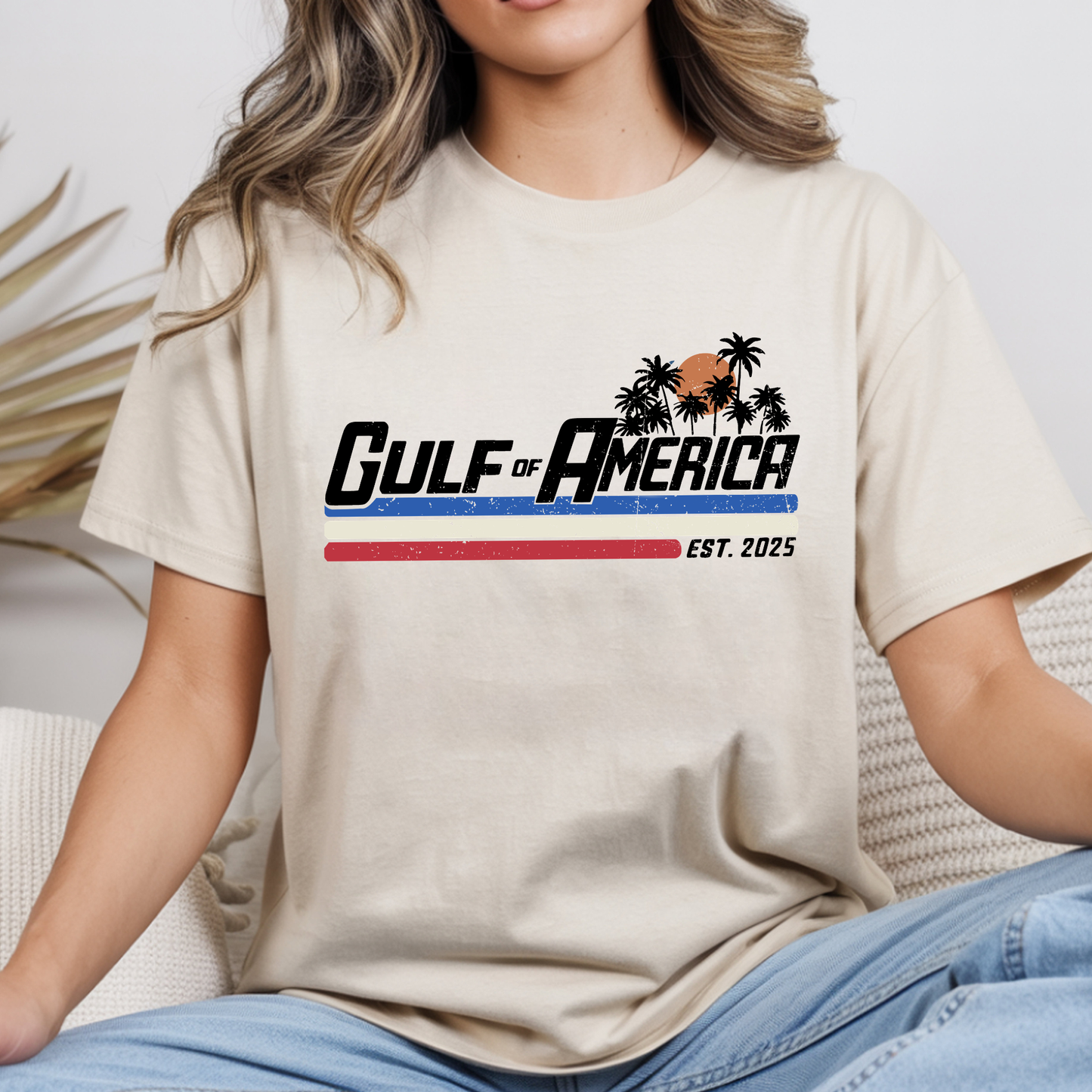 Person wearing a beige t-shirt with 'Gulf of America' design
