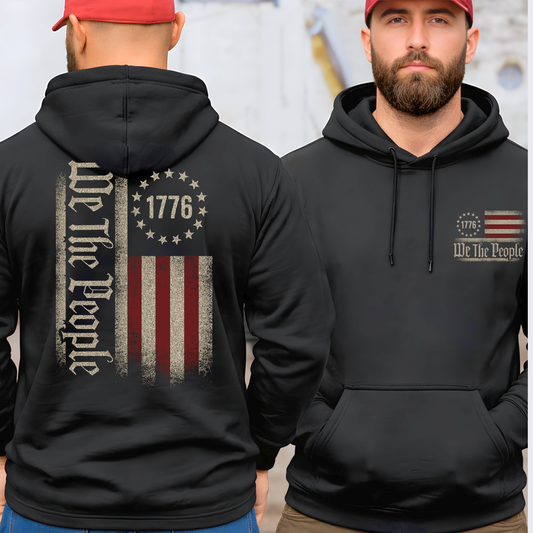Black hoodie with 'We the People' and 1776 design on front and back worn by a person.