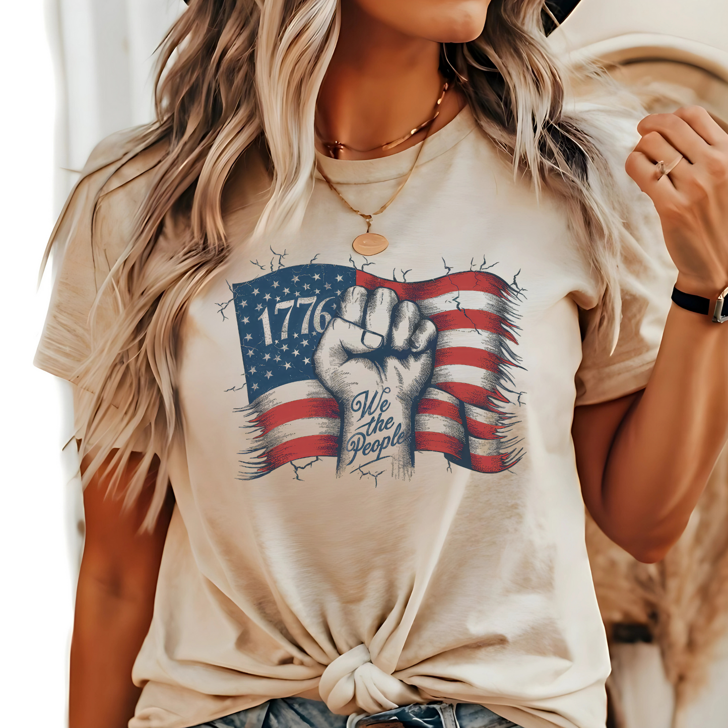 Woman sitting in neutral 1776 shirt outdoors with rustic wood background.