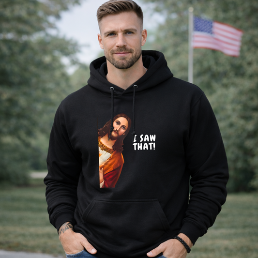 Man wearing a black hoodie with a graphic design and text, standing outdoors.