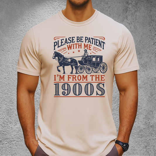 Male model wearing sand color T-shirt with vintage horse carriage design and Please Be Patient With Me I’m From the 1900s text – casual retro graphic tee