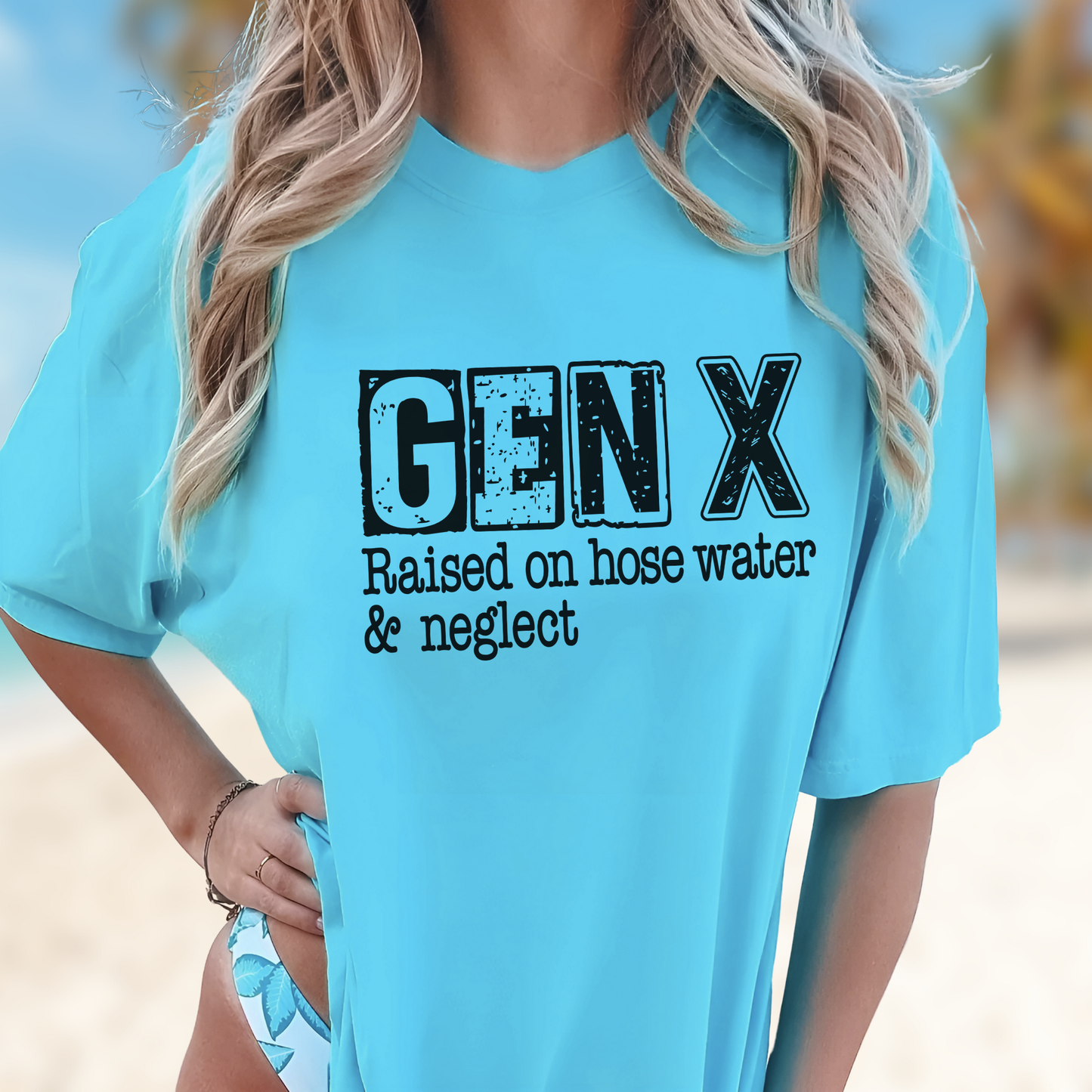 Beach-style sky blue shirt with Gen X quote graphic over swimsuit