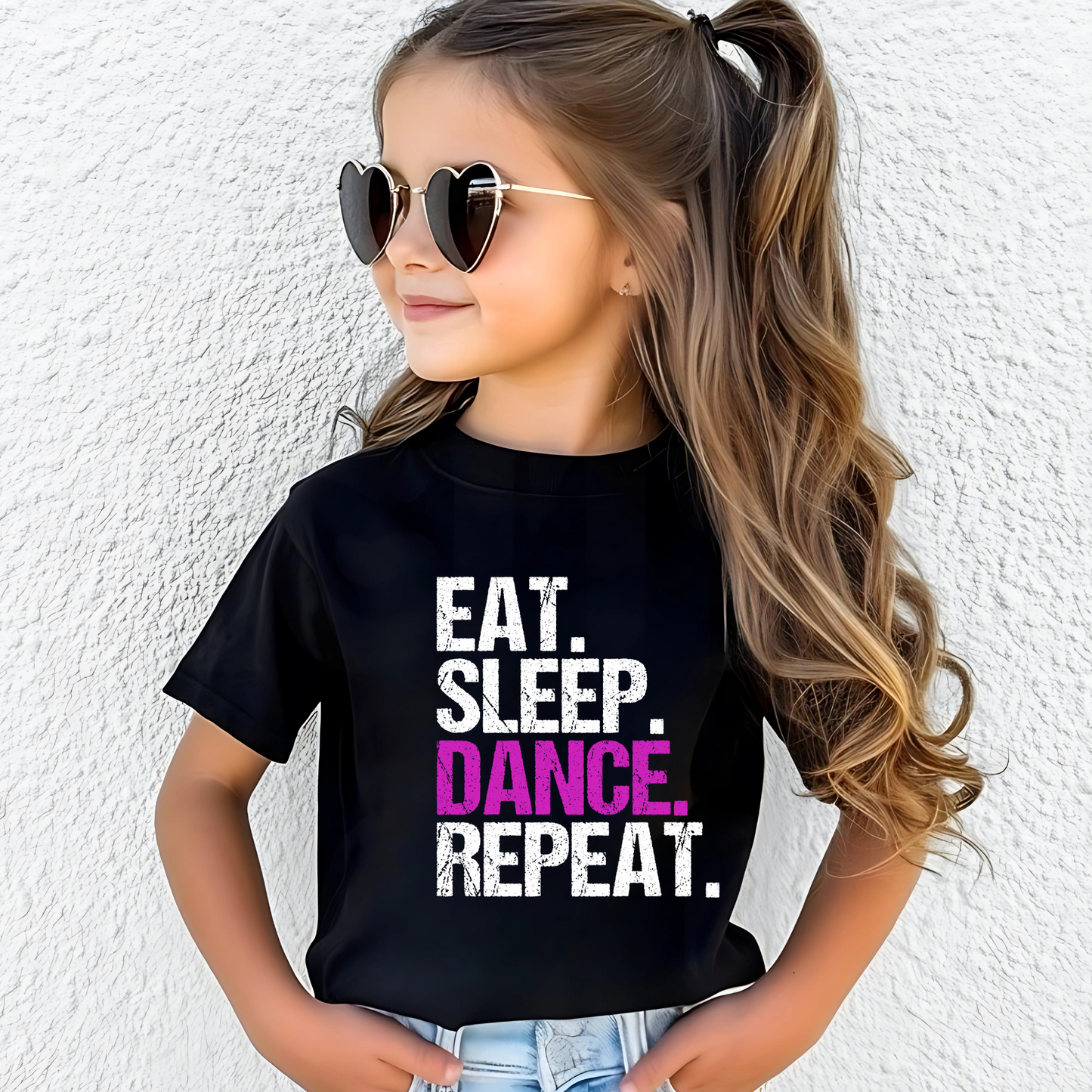 Dance all day in this trendy ‘Eat. Sleep. Dance. Repeat.’ T-shirt! Made for comfort and style, this tee is perfect for hip-hop, ballet, and jazz dancers. A must-have for any dance lover!