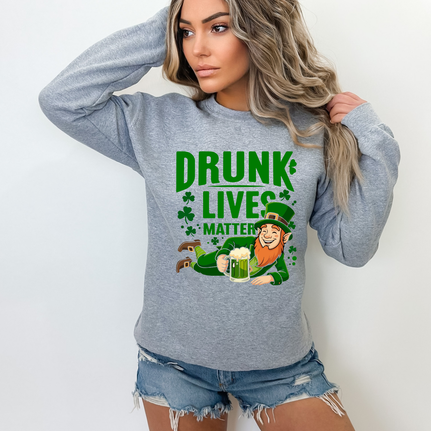 Woman wearing a gray “Drunk Lives Matter” sweatshirt with leprechaun graphic, St. Patrick’s Day outfit