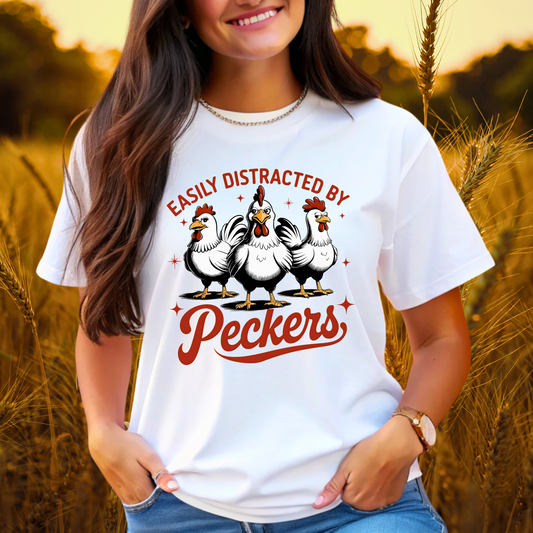 Woman wearing a WHITE T-shirt with Easily Distracted by Peckers text and three funny cartoon chickens design. Perfect for chicken lovers and humor enthusiasts