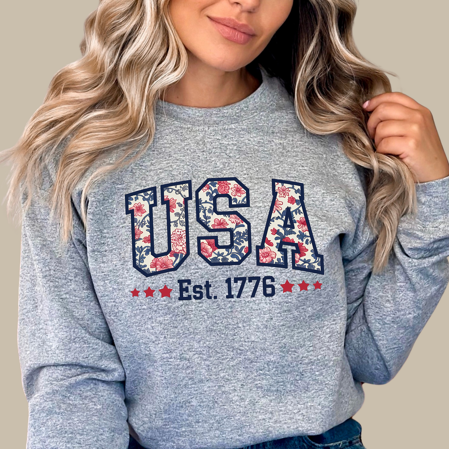 Gray fleece USA Est. 1776 sweatshirt with floral lettering – casual patriotic apparel.
