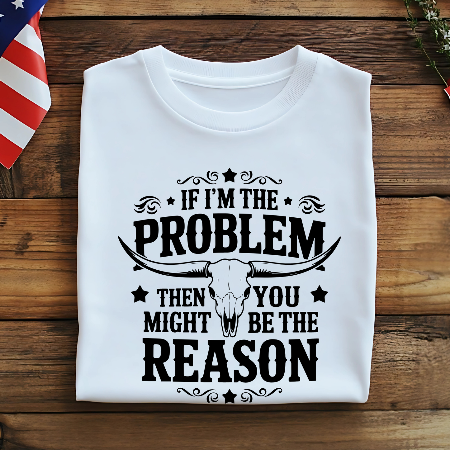 Folded white shirt – flat lay with patriotic decor and bold black print