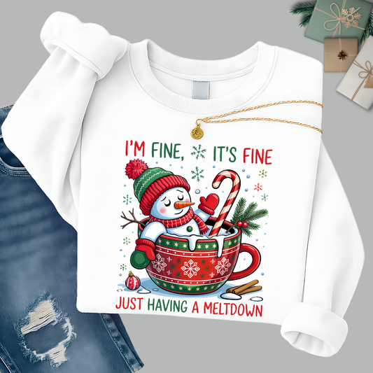 Flat lay of white snowman sweatshirt styled with denim and gift boxes