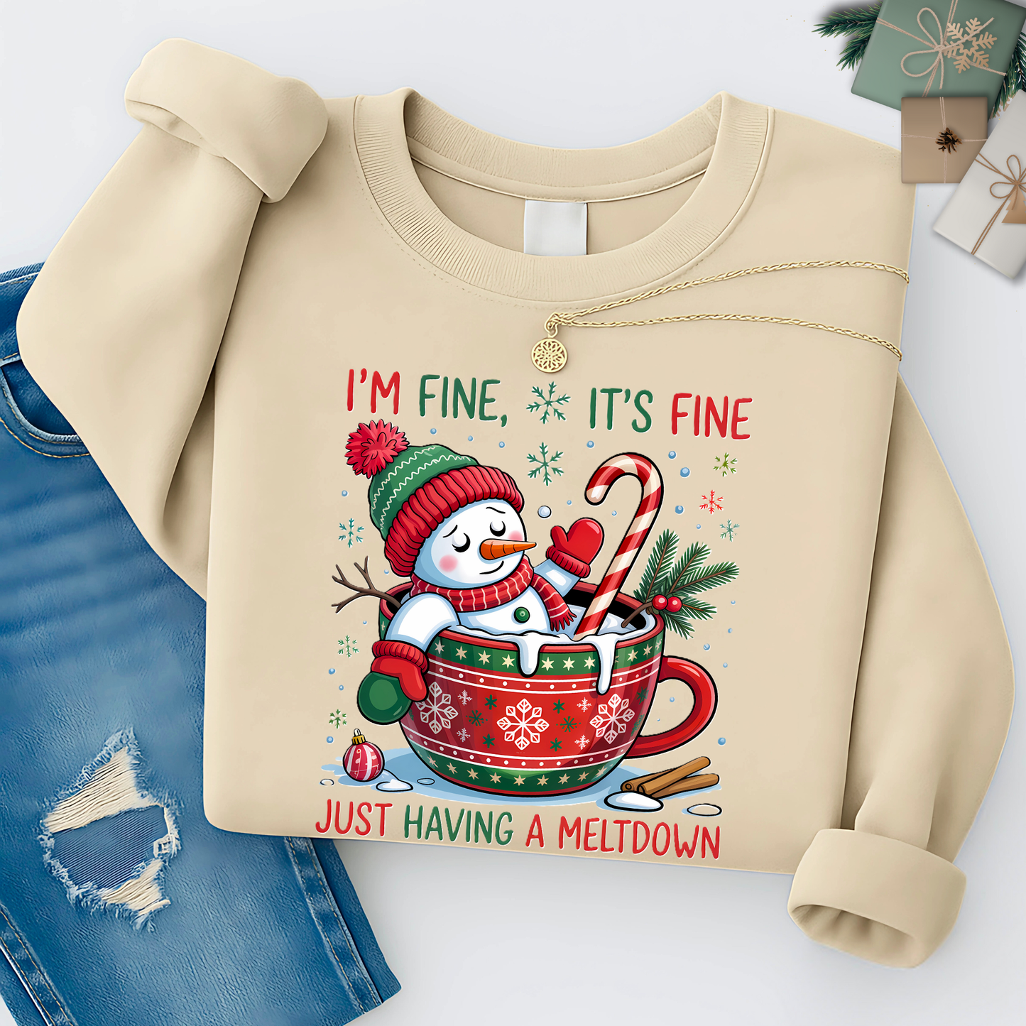 Beige sweatshirt with a Christmas-themed design featuring a snowman and text on a white background.