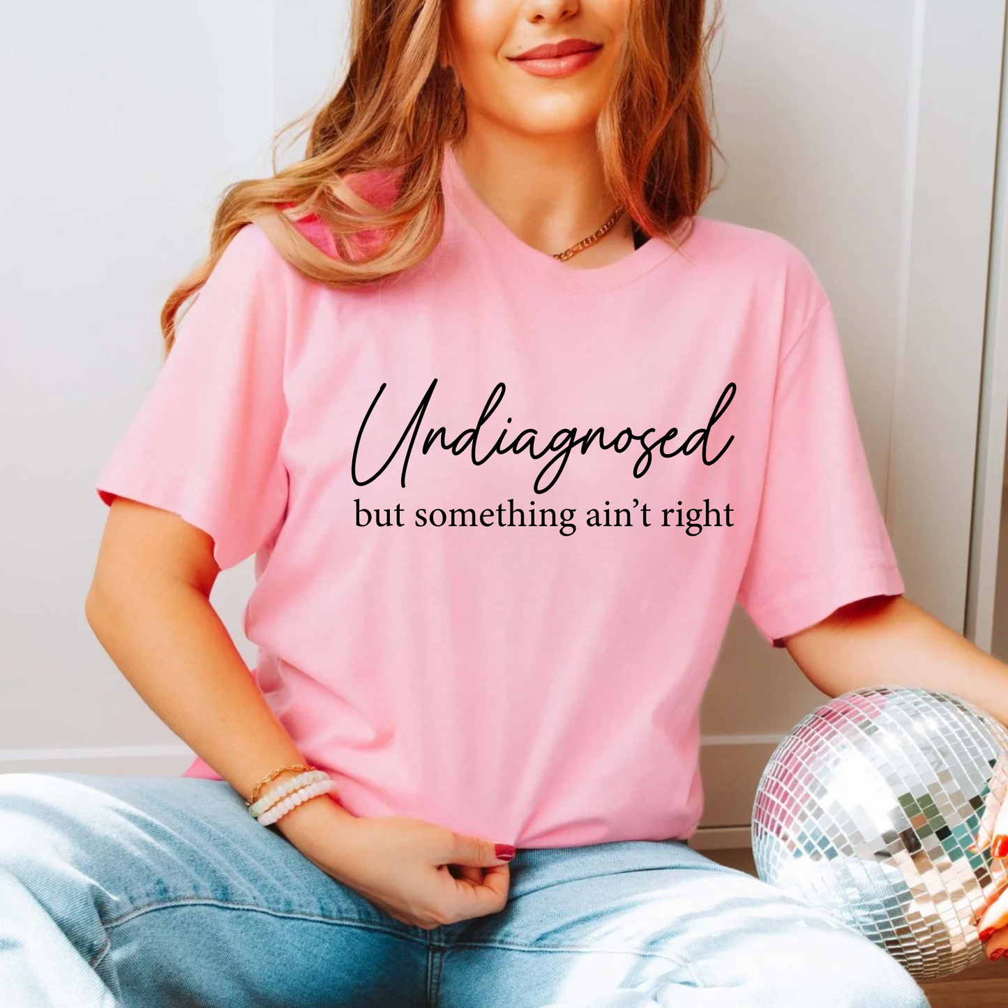 Light Pink shirt styled with jeans, script quote in Black text