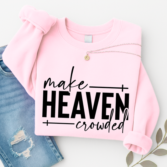 Make Heaven Crowded design on light pink sweatshirt folded with jeans