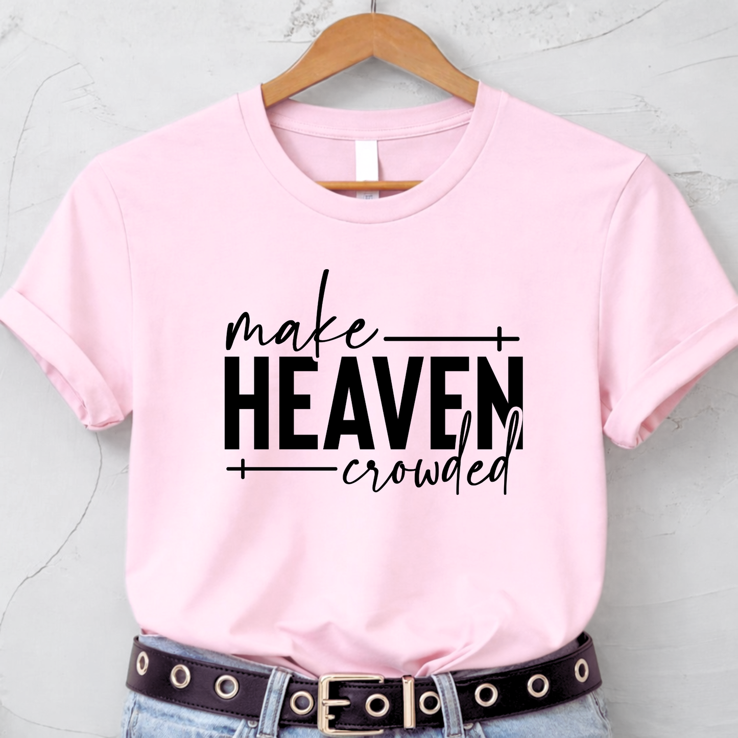 Make Heaven Crowded design on pink short sleeve shirt flat lay