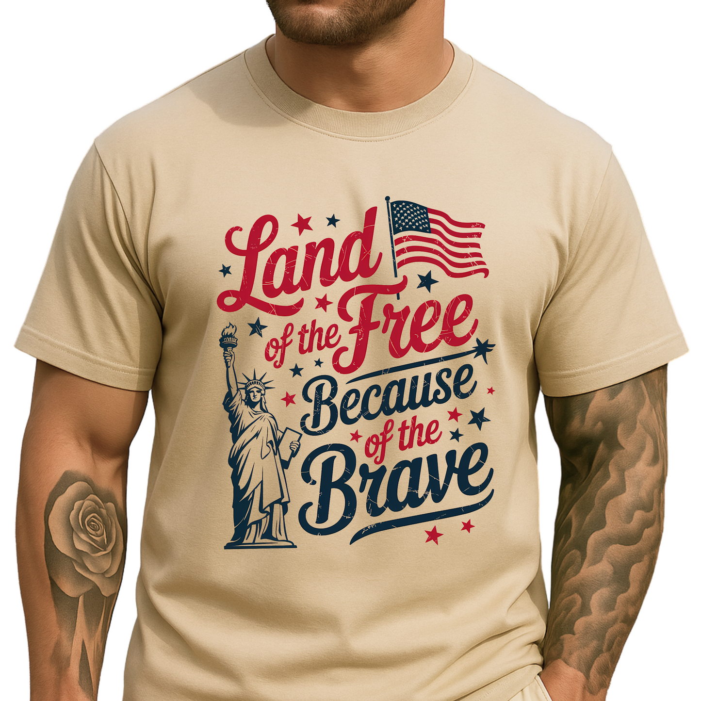 Man wearing a sand-colored t-shirt with patriotic “Land of the Free Because of the Brave” design