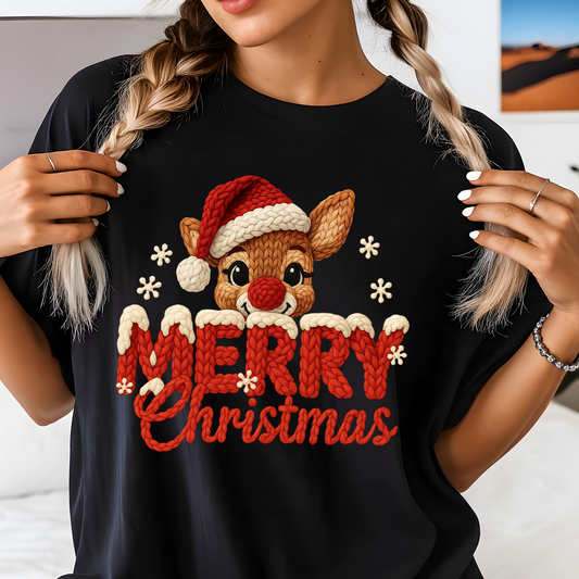 Person wearing a black t-shirt with a Christmas-themed design featuring a reindeer and 'Merry Christmas' text.