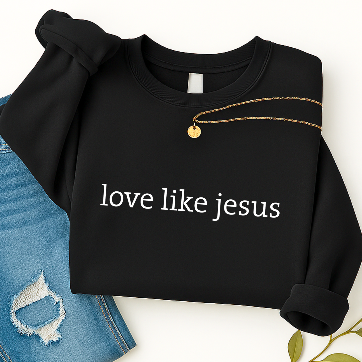 Black sweatshirt with 'love like jesus' text on a white background