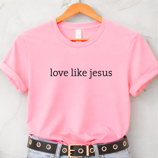 Pink women’s T-shirt on hanger featuring “love like jesus” minimalist text design