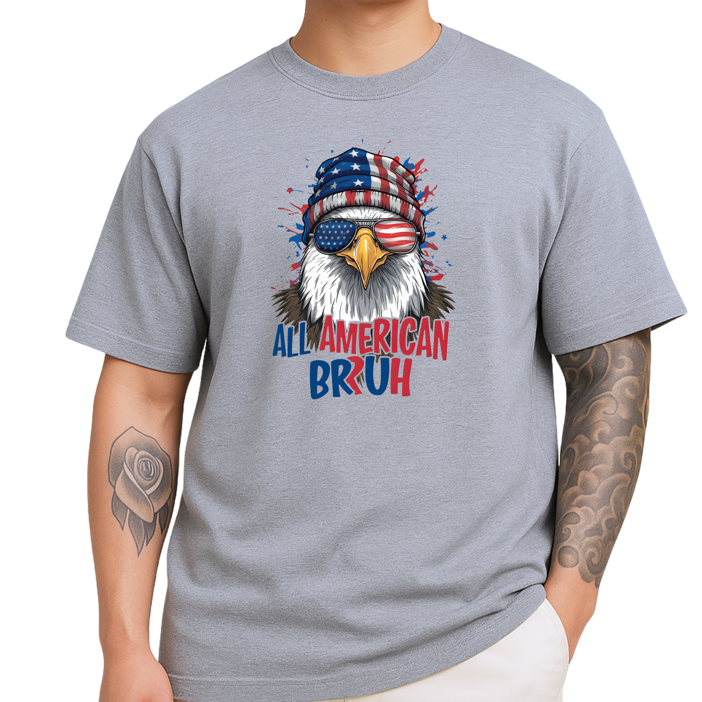 Patriotic men’s T-shirt in sports gray featuring a detailed bald eagle wearing American flag beanie and USA sunglasses. “All American Bruh” text in bold red and blue. Ideal for July 4th BBQs, military events, or as a funny gift for patriotic guys.
