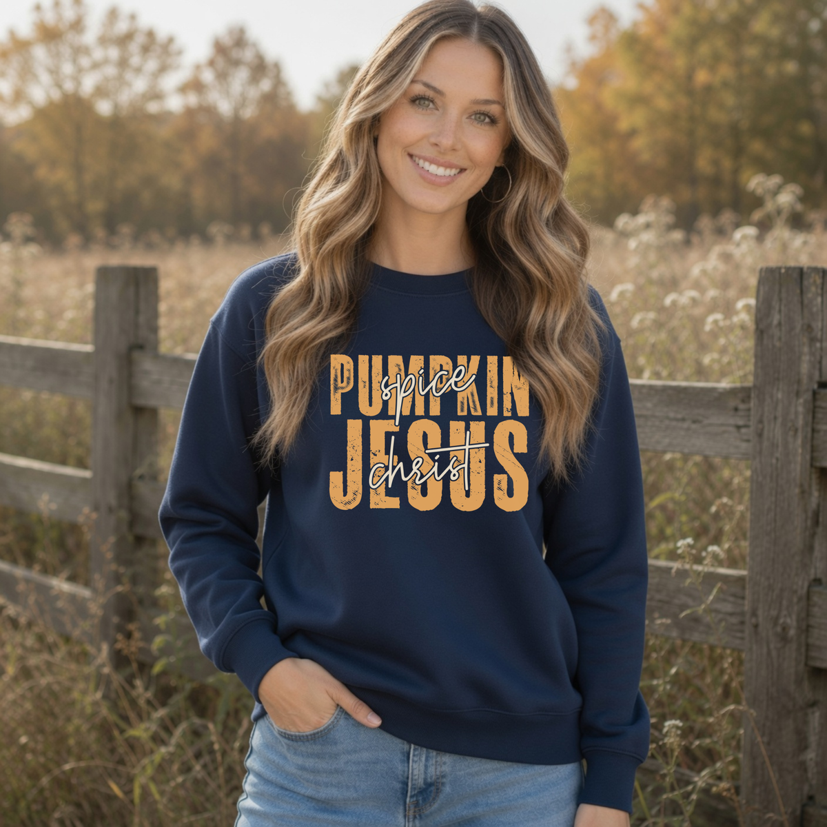 Woman wearing a navy Pumpkin Spice and Jesus Christ sweatshirt outdoors beside a rustic fence