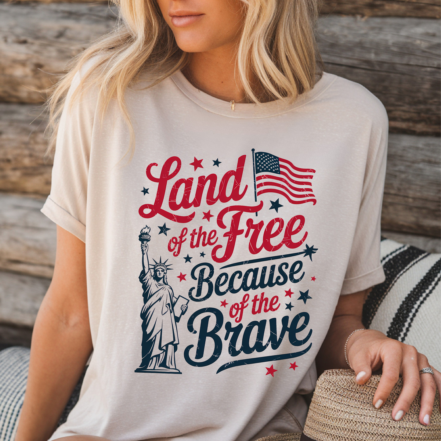 Woman lounging in light sand shirt with bold patriotic text