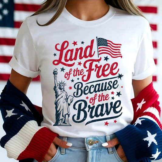 Woman in white tee with red/blue patriotic print, smiling in front of flag