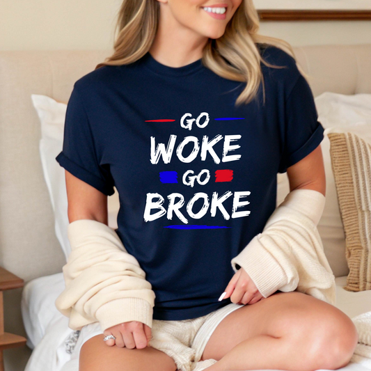 Woman sitting on bed in navy “Go Woke Go Broke” shirt styled with cozy cardigan
