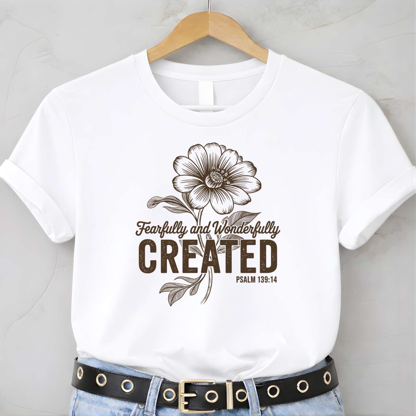 White youth t-shirt with Fearfully and Wonderfully Created floral design on hanger