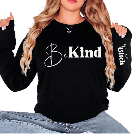 Black sweatshirt with 'Be Kind' text, worn by a person.