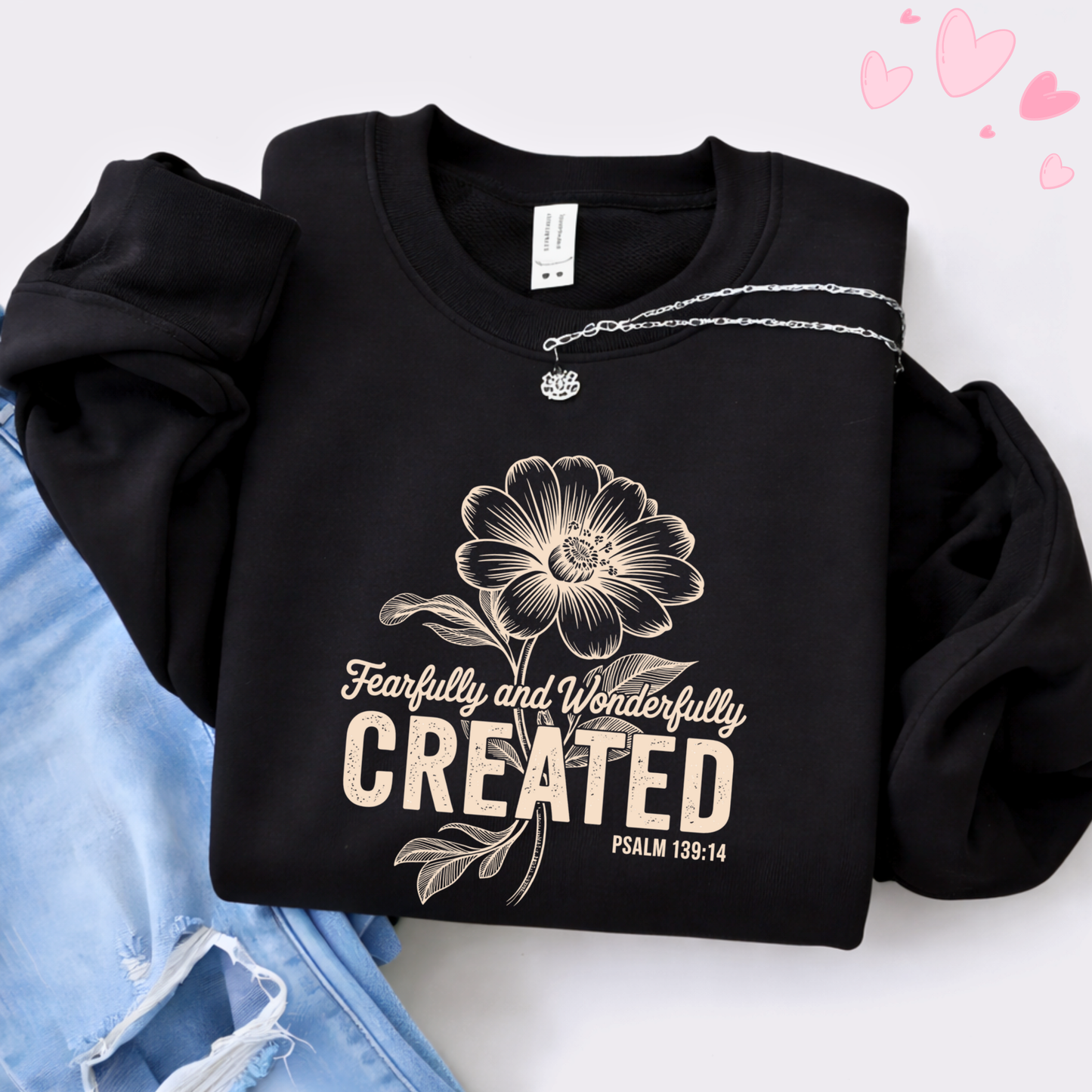 Cream t-shirt with Fearfully and Wonderfully Created floral design worn with jeans