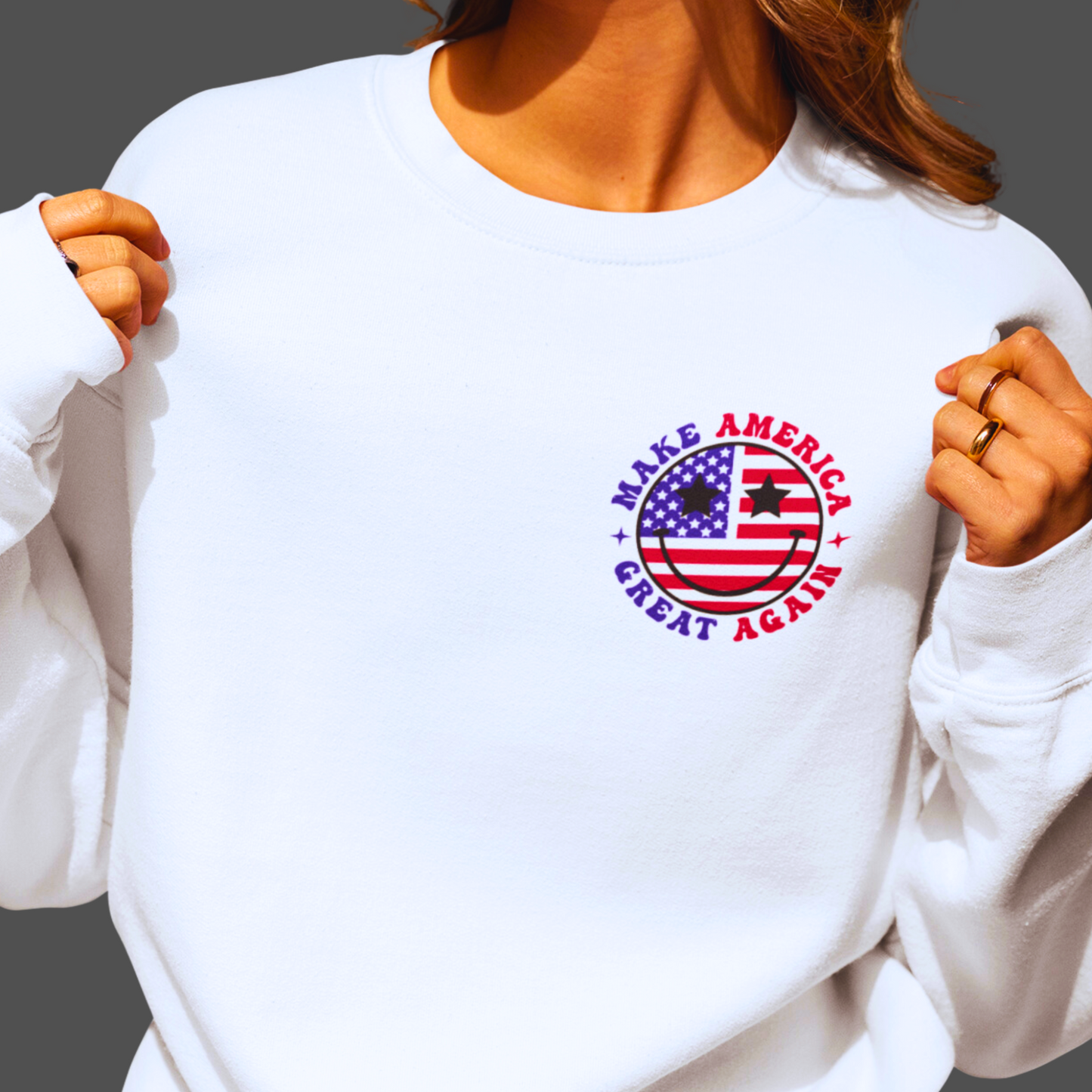 White sweatshirt front view with round USA flag graphic and patriotic text