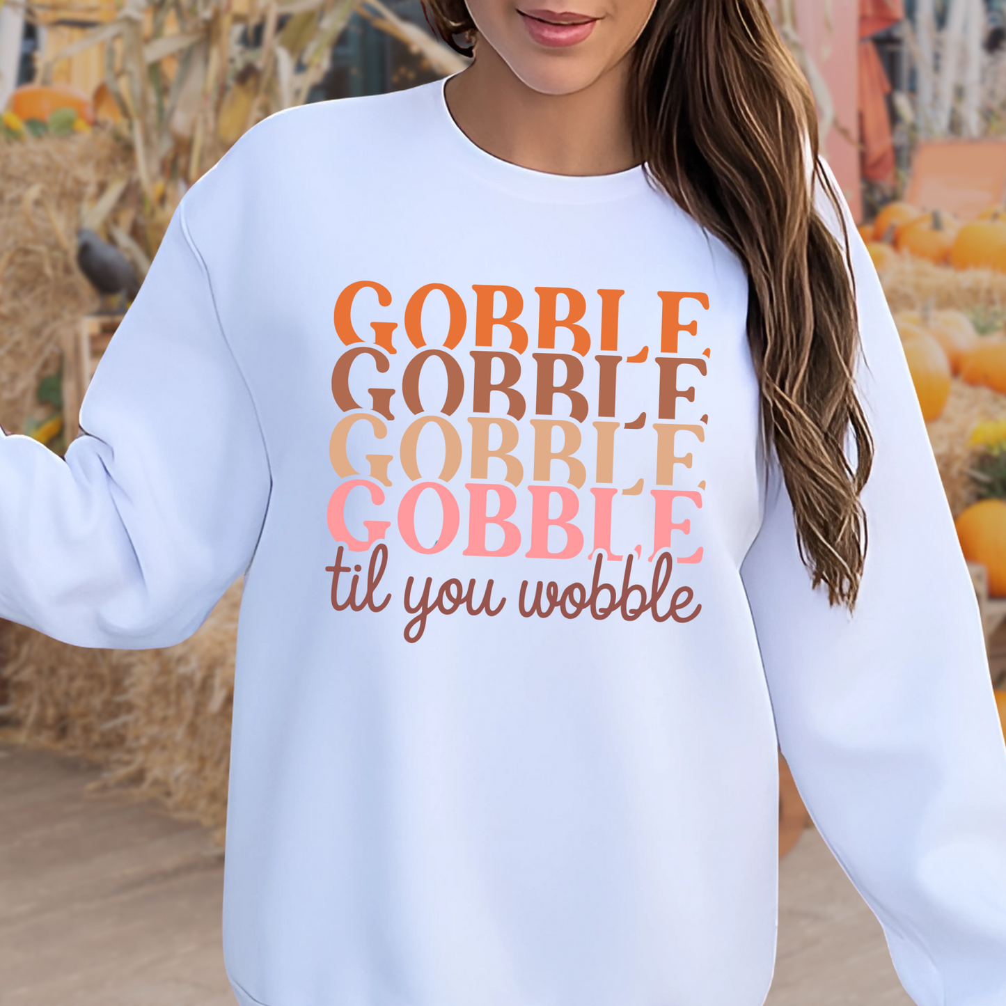 White sweatshirt with multicolor “Gobble Til You Wobble” design – perfect for fall family gatherings and seasonal style.