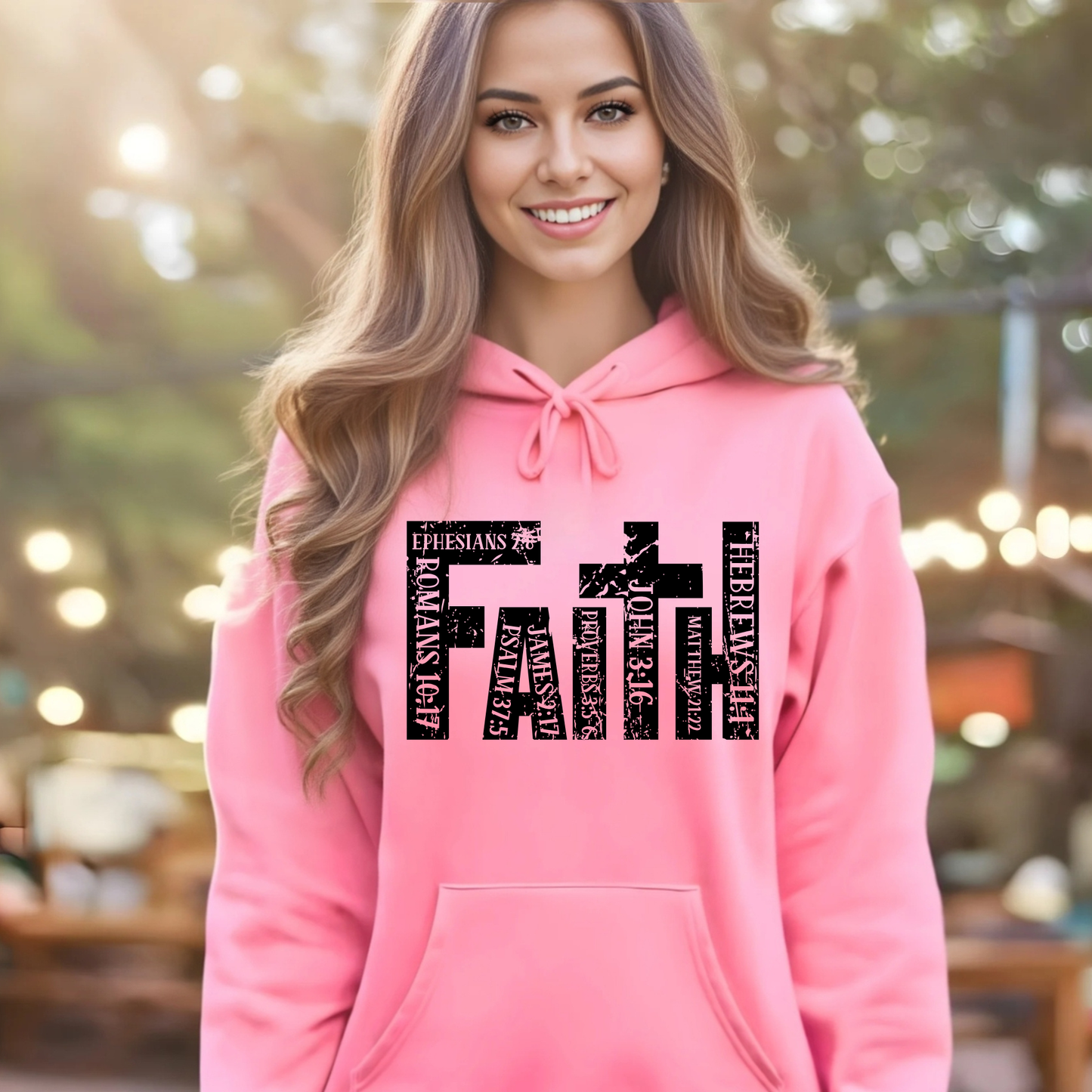 Woman wearing pink unisex Christian hoodie with distressed faith cross graphic