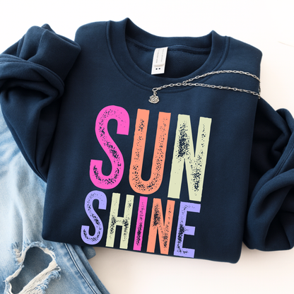 Navy blue sweatshirt with 'SUNSHINE' in colorful letters on a light background