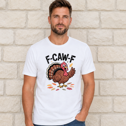 Man wearing a white T-shirt with a colorful F-CAW-F turkey graphic against a light stone wall.