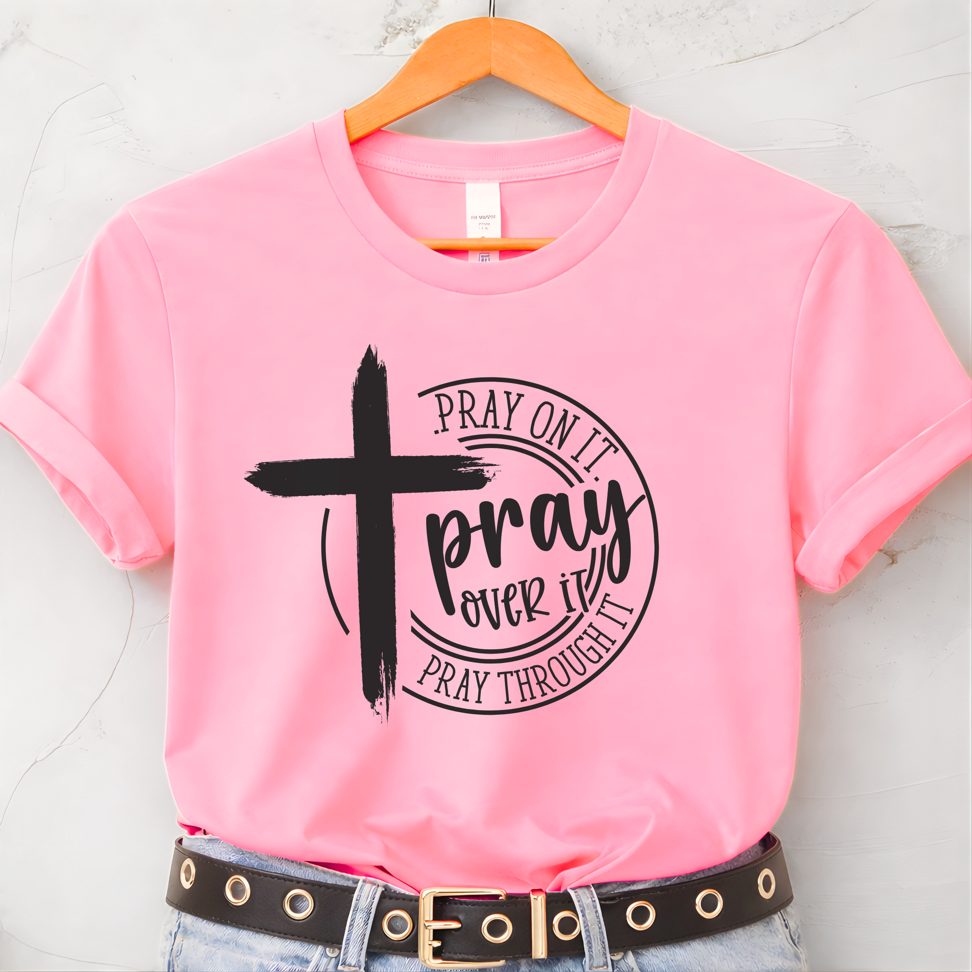 Pink Pray Over It Christian t-shirt flat lay with black cross prayer graphic