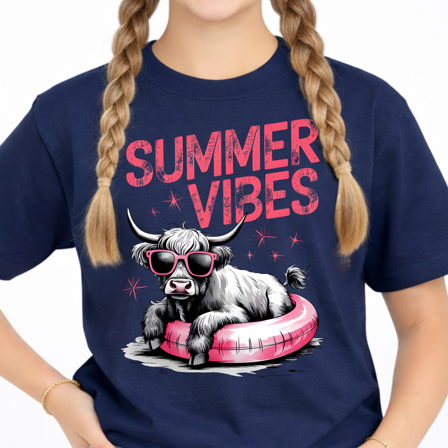 Close up of a youth navy blue t-shirt with a highland cow graphic and 'Summer Vibes' text.
