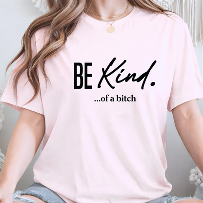 Woman wearing a pink t-shirt with 'BE KIND...of a bitch' text.