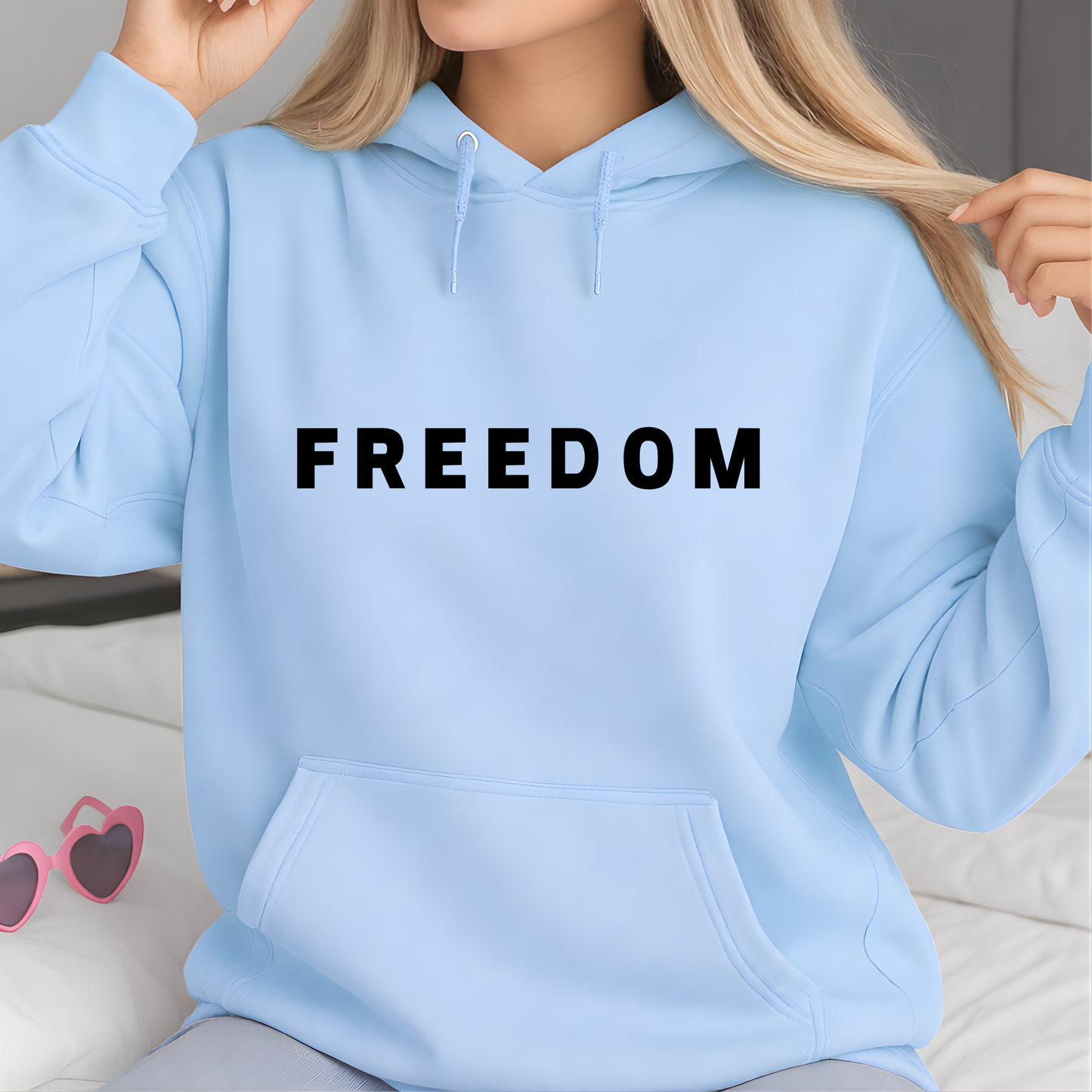 Woman wearing light blue FREEDOM sweatshirt front view