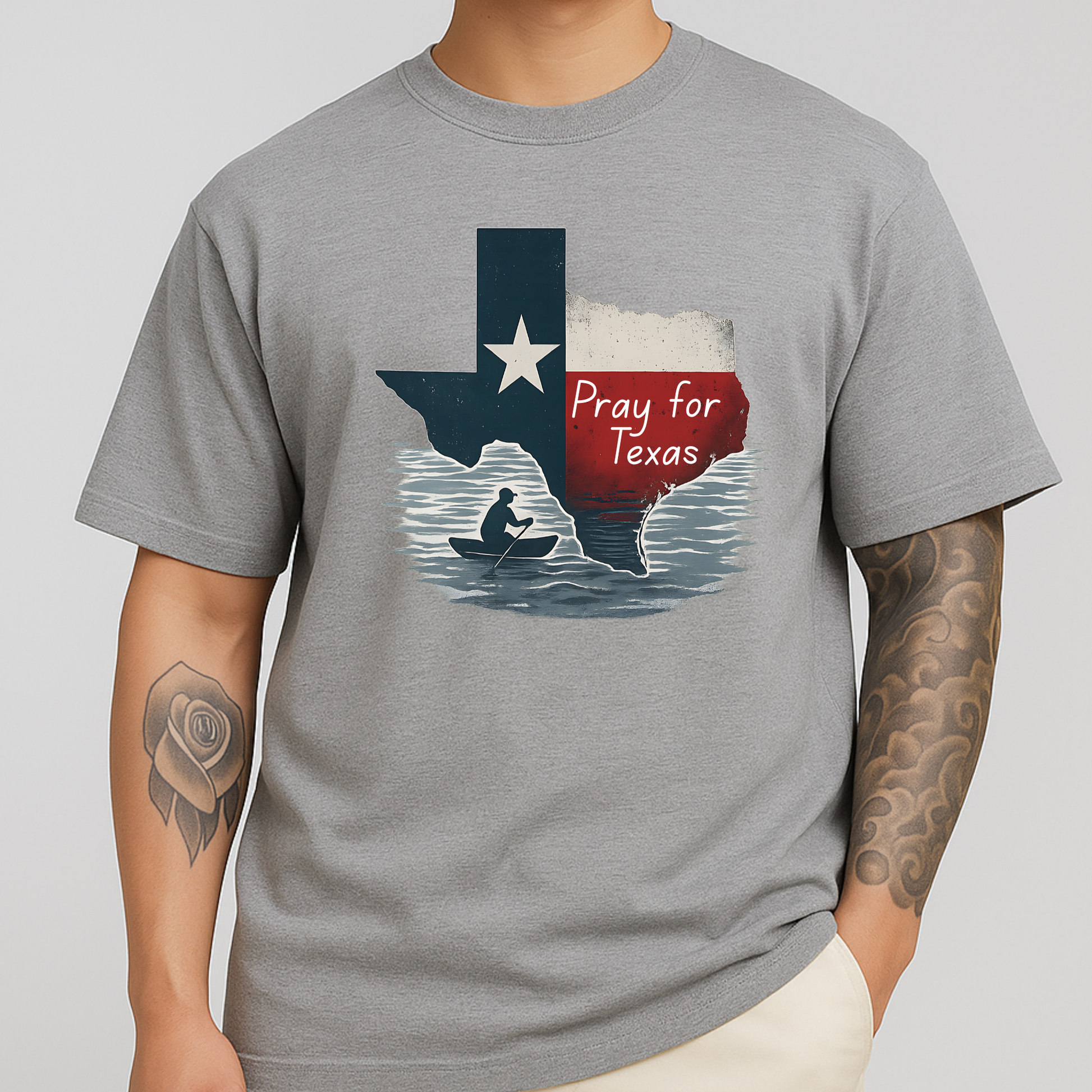 Gray unisex Pray for Texas graphic tee with rustic Texas flag and canoe design. A comfortable, casual shirt ideal for Texas pride and everyday wear.