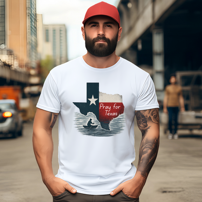 White Pray for Texas T-shirt in a unisex fit, styled for men with a red Texas cap. Features distressed Texas flag artwork with canoe silhouette for a bold, supportive look.