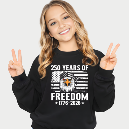 Young girl wearing a black sweatshirt with an eagle and American flag design, making peace signs.