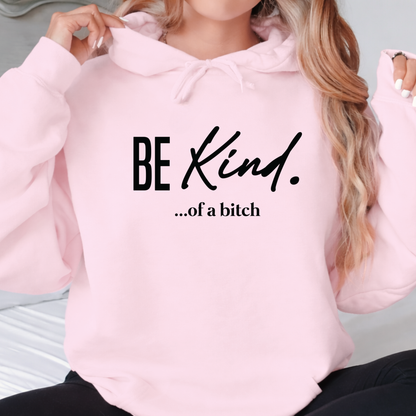 Pink hoodie with 'BE Kind. ...of a bitch' text worn by a person.