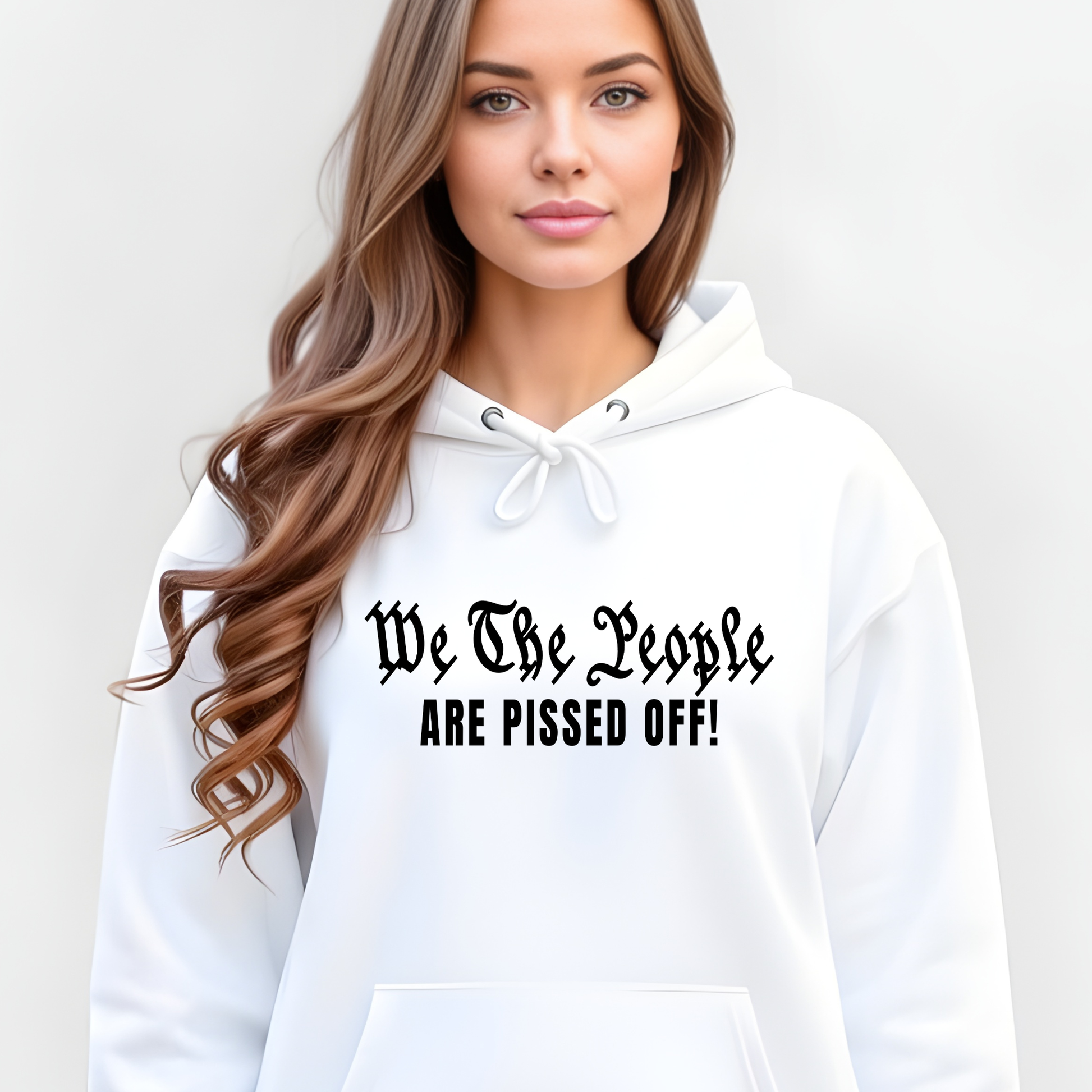 Woman wearing a white hoodie with text 'We The People ARE PISSED OFF!' on a plain background