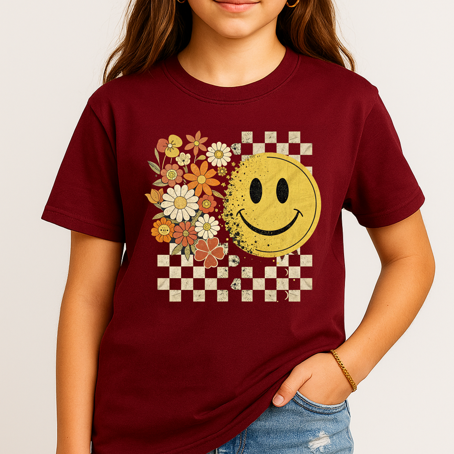Youth girl wearing fall smiley face t-shirt with floral and checkerboard design
