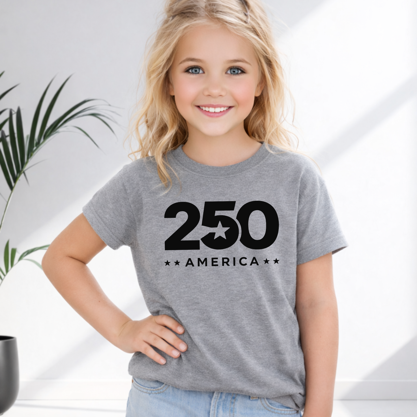 Young girl wearing a gray t-shirt with '250 America' design on a light background