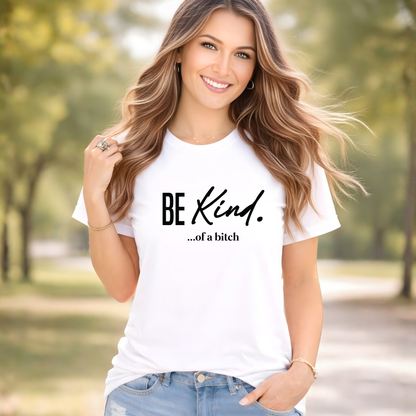 Woman wearing a white t-shirt with 'BE Kind...of a bitch' text in a park.