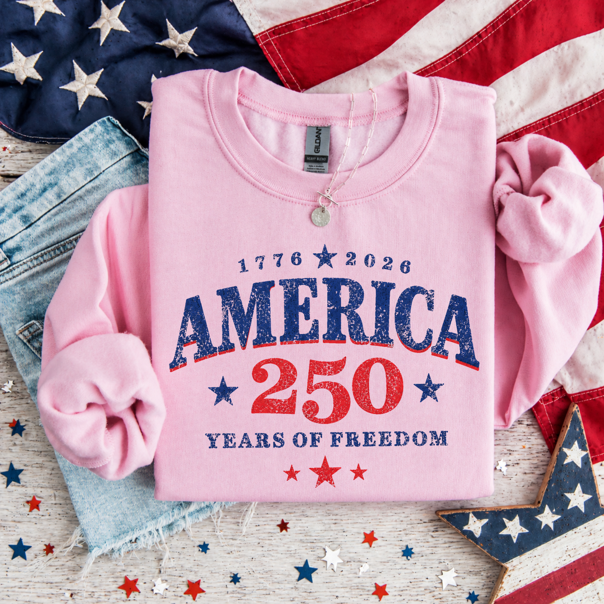 Pink sweatshirt with 'America 250 Years of Freedom' text on an American flag background