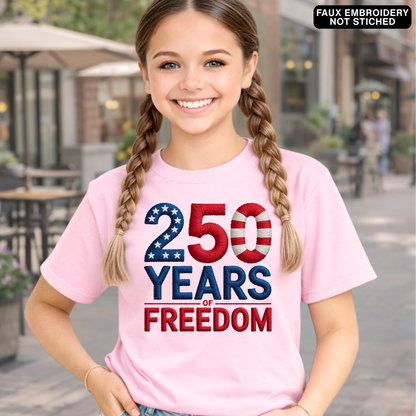 Young girl wearing a pink t-shirt with '250 Years of Freedom' design outdoors.