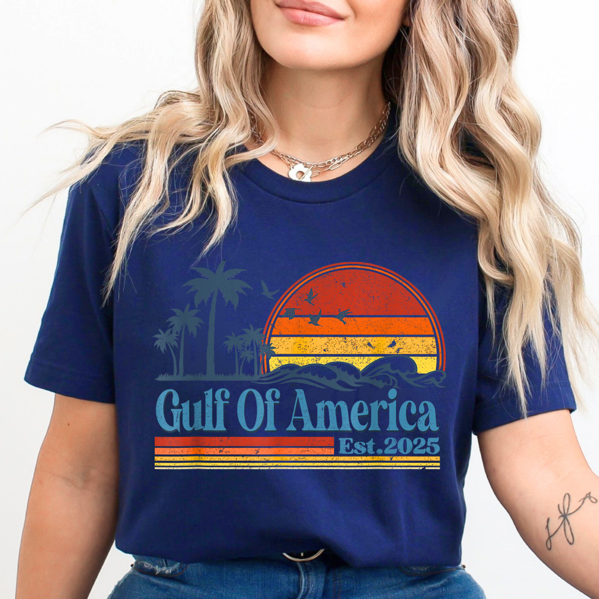Woman wearing a blue t-shirt with 'Gulf Of America Est. 2025' design.